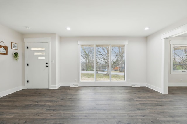 foyer featuring recessed lighting, visible vents, dark wood finished floors, and baseboards