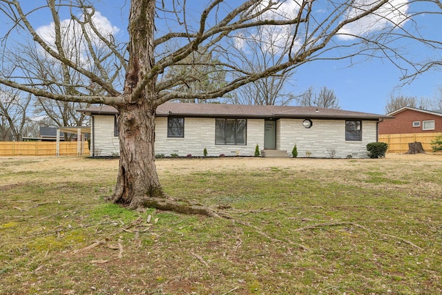 ranch-style home with stone siding, a front lawn, and fence