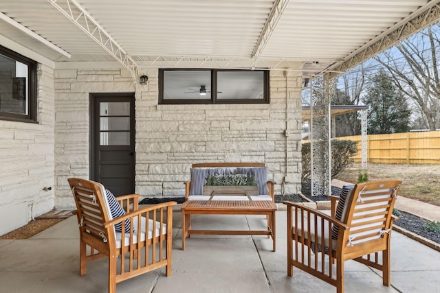 view of patio featuring fence and an outdoor living space