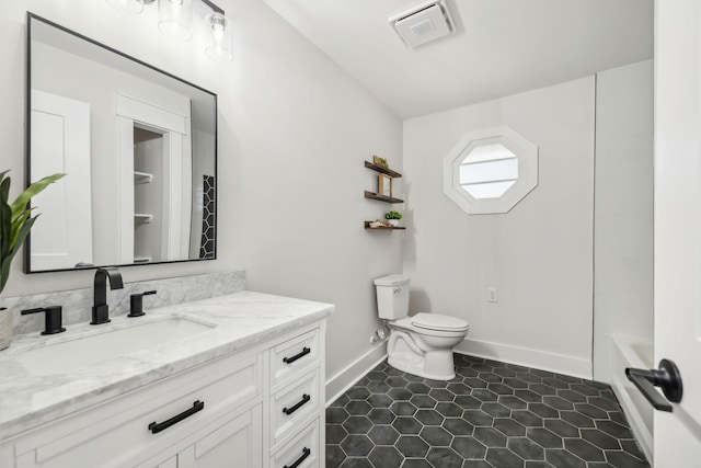 full bath with baseboards, visible vents, toilet, tile patterned floors, and vanity