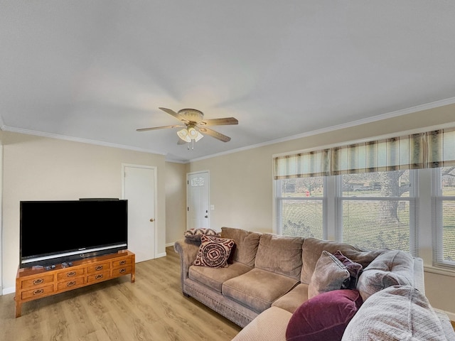 living area featuring crown molding, baseboards, a ceiling fan, and light wood-style floors