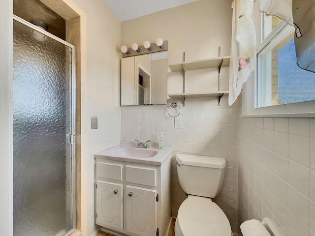 full bathroom featuring tile walls, a shower stall, toilet, and vanity