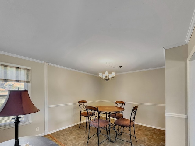 dining room featuring a wealth of natural light, crown molding, baseboards, and an inviting chandelier