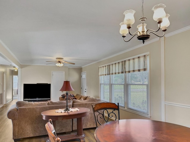 living area with ornamental molding and wood finished floors