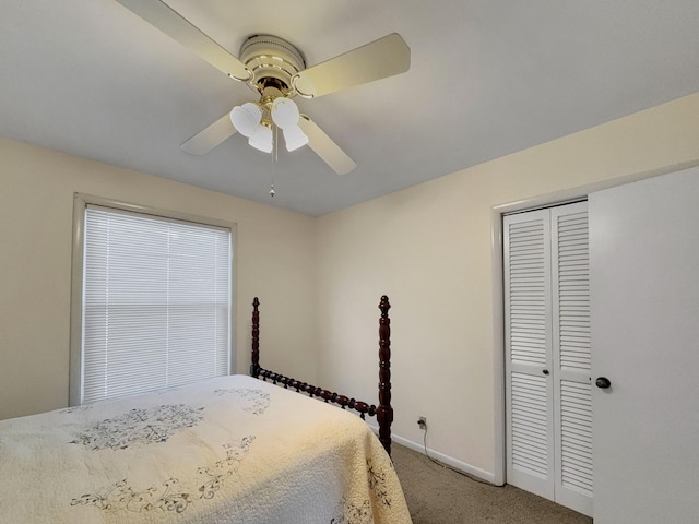 bedroom with baseboards, a ceiling fan, a closet, and light colored carpet