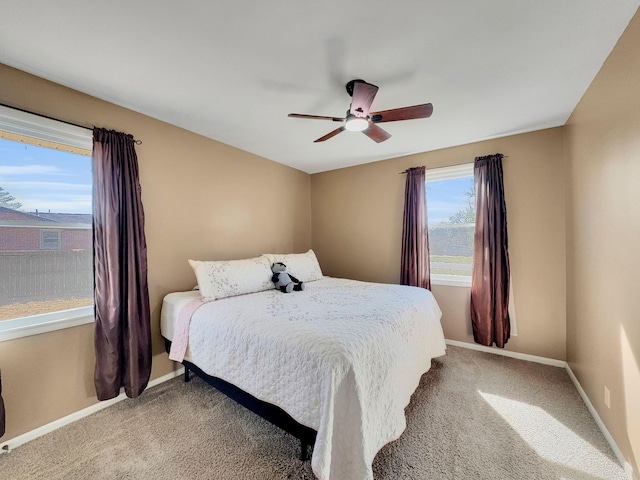 bedroom with light carpet, ceiling fan, and baseboards