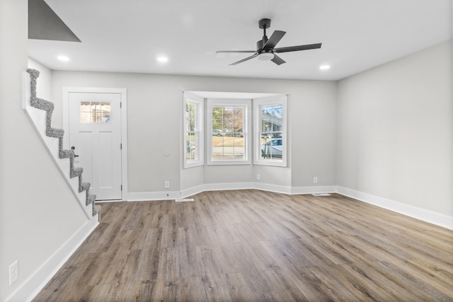 foyer with recessed lighting, stairway, ceiling fan, wood finished floors, and baseboards