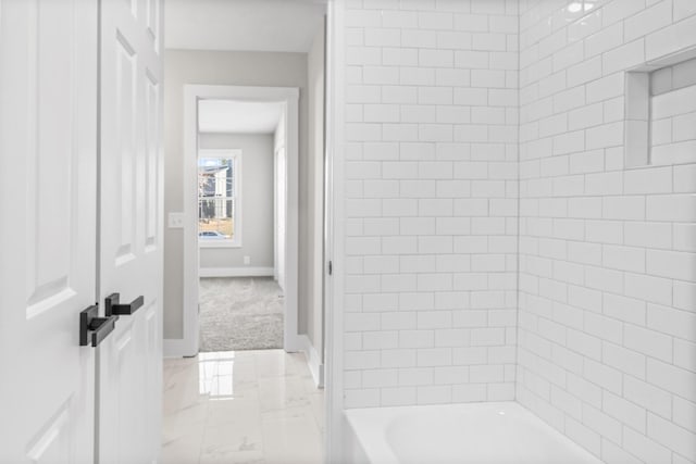 full bathroom featuring marble finish floor, shower / washtub combination, and baseboards