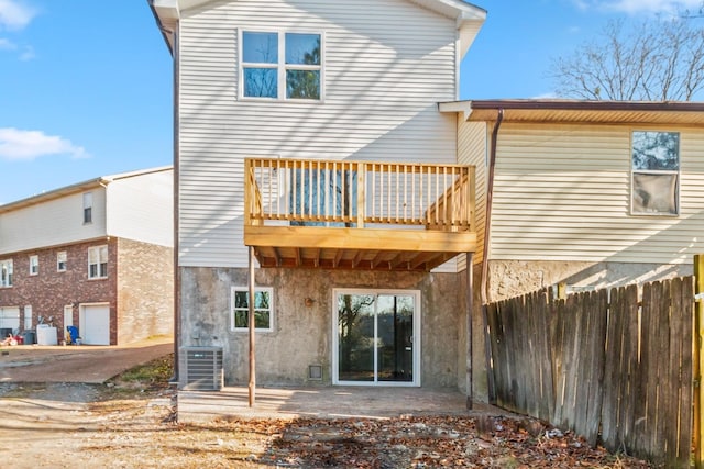 rear view of house with central air condition unit, a patio area, and fence