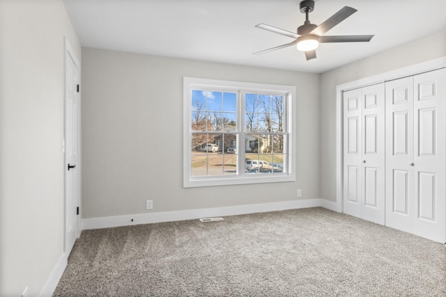 unfurnished bedroom featuring carpet floors, a closet, and baseboards