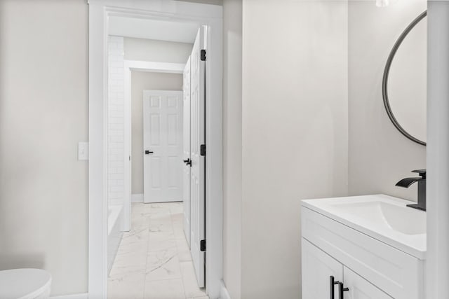 bathroom with marble finish floor, toilet, vanity, baseboards, and walk in shower