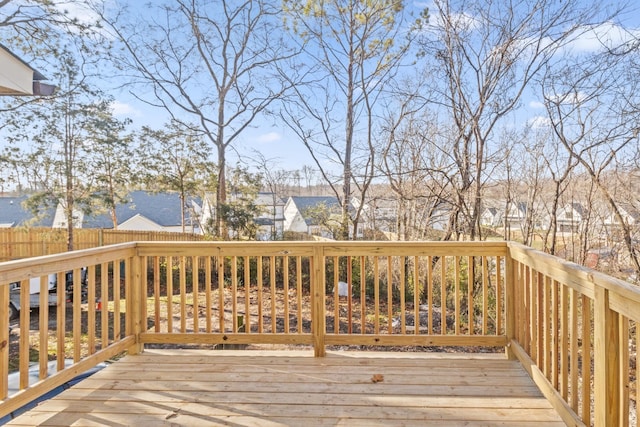 wooden terrace featuring a residential view and fence