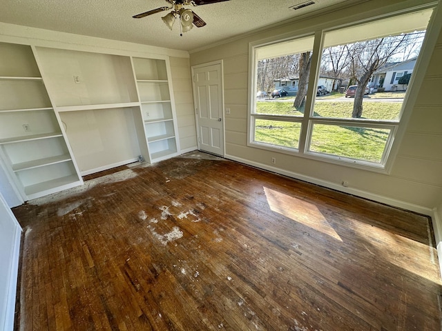 interior space featuring visible vents, dark wood finished floors, and a textured ceiling