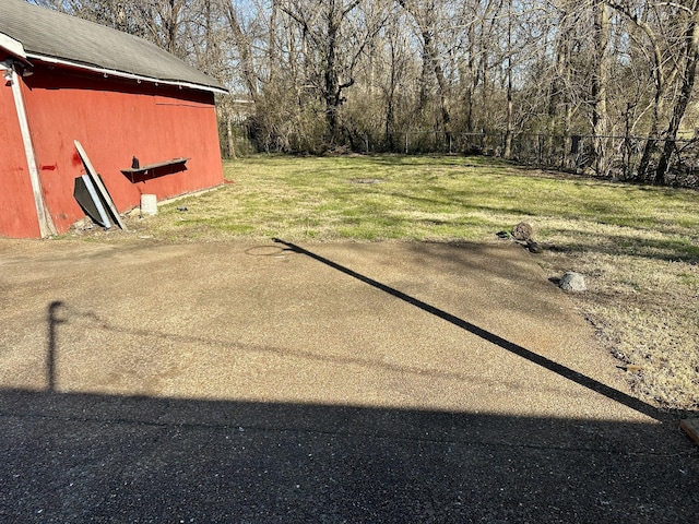 view of yard with fence and an outdoor structure