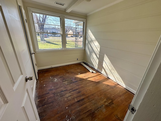 unfurnished room with visible vents, dark wood-style flooring, and ornamental molding