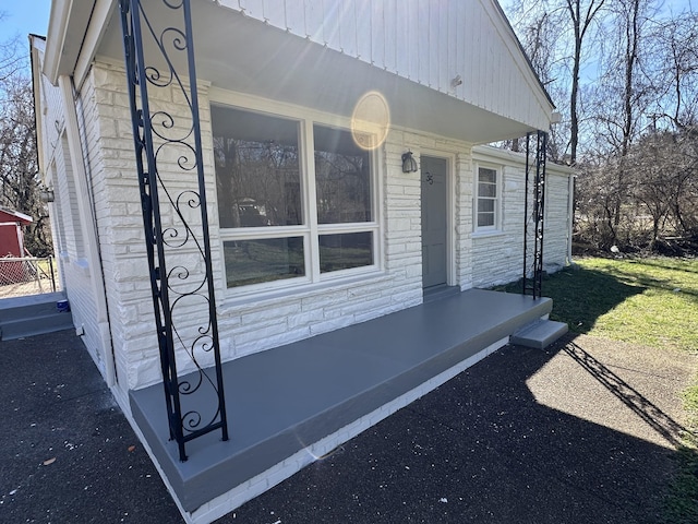 property entrance featuring stone siding