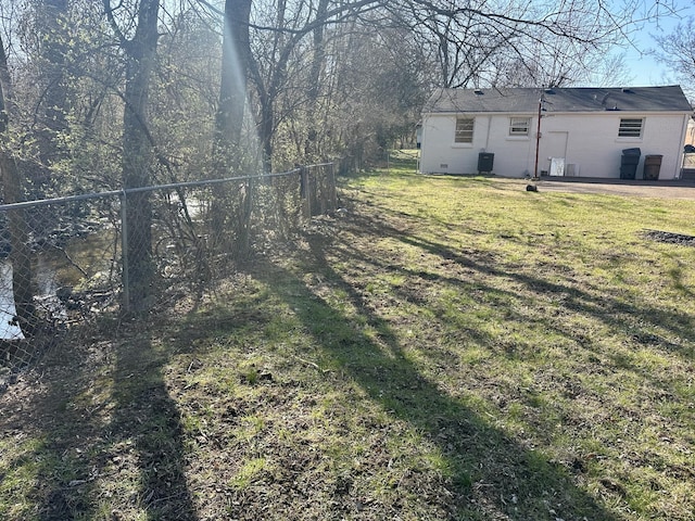 view of yard featuring central air condition unit and fence