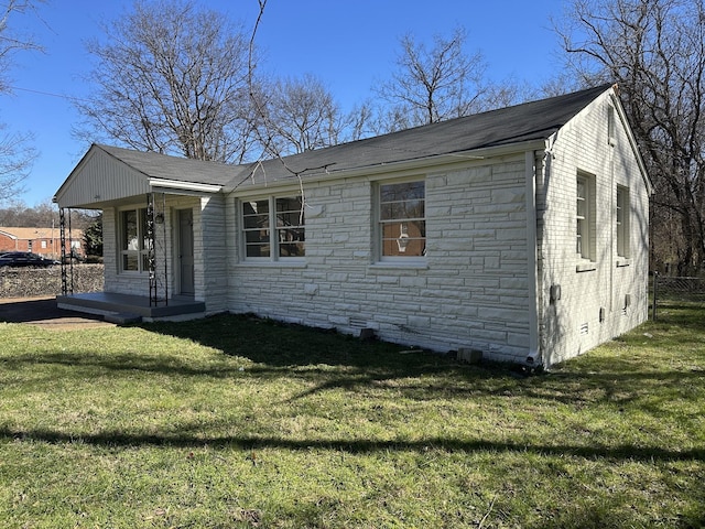 view of front of property with crawl space, stone siding, fence, and a front yard