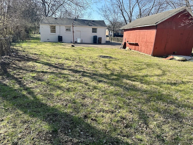 view of yard with fence and an outdoor structure