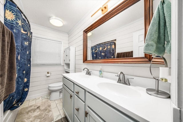 bathroom featuring double vanity, wooden walls, and a sink