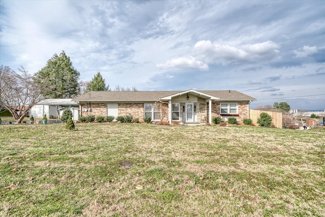 ranch-style home with a front lawn and fence