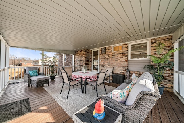 wooden terrace featuring outdoor dining area