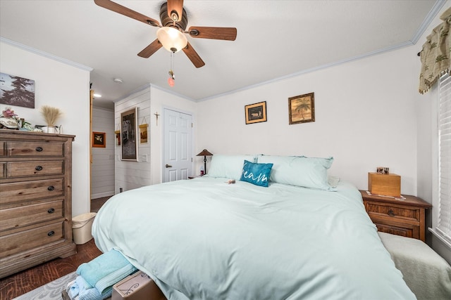 bedroom featuring ornamental molding, dark wood finished floors, and a ceiling fan