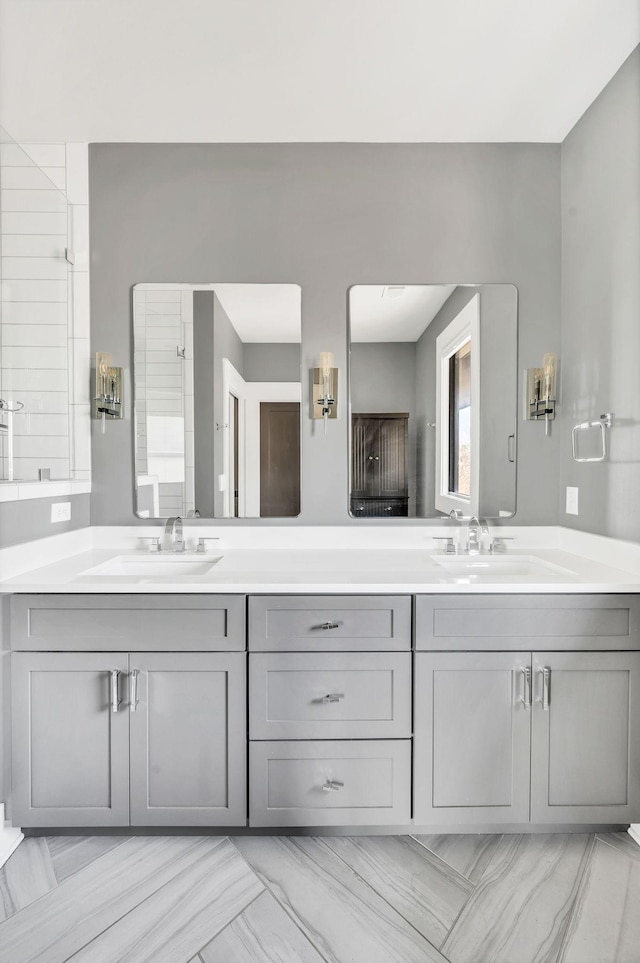 bathroom with a sink and double vanity