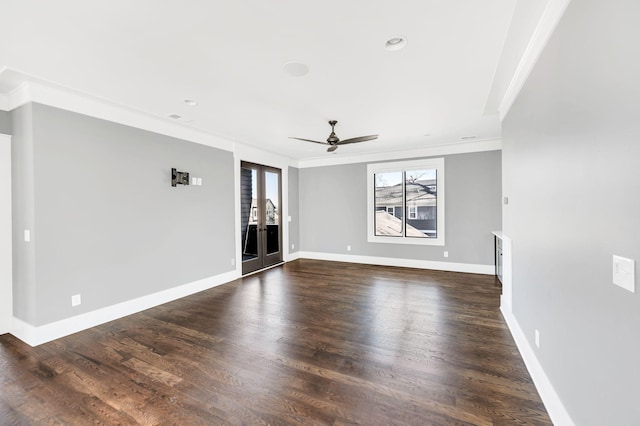 unfurnished living room with dark wood-style flooring, visible vents, a ceiling fan, baseboards, and ornamental molding