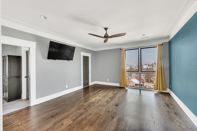 unfurnished room with a ceiling fan, baseboards, wood finished floors, and ornamental molding