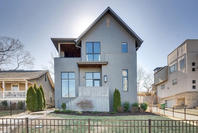 view of front of property with brick siding and fence