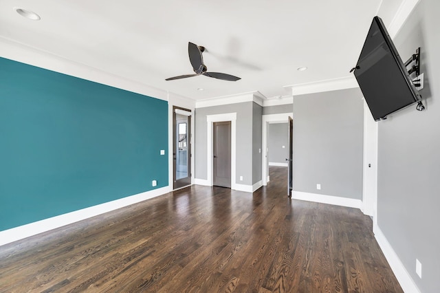 empty room with ceiling fan, baseboards, wood finished floors, and ornamental molding