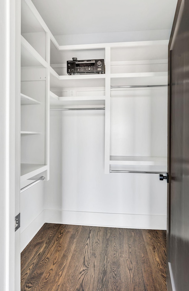 spacious closet with dark wood-style floors