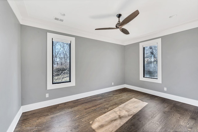 unfurnished room featuring a ceiling fan, visible vents, baseboards, ornamental molding, and dark wood finished floors