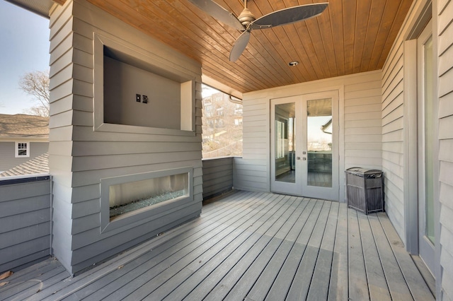 deck with french doors and ceiling fan