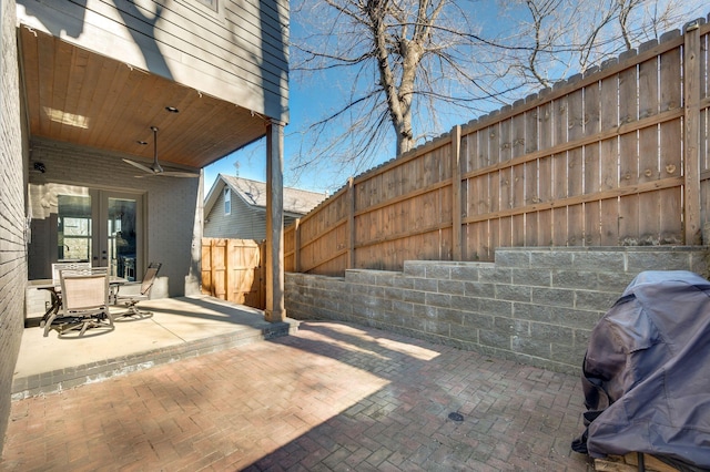 view of patio with french doors, grilling area, and a fenced backyard