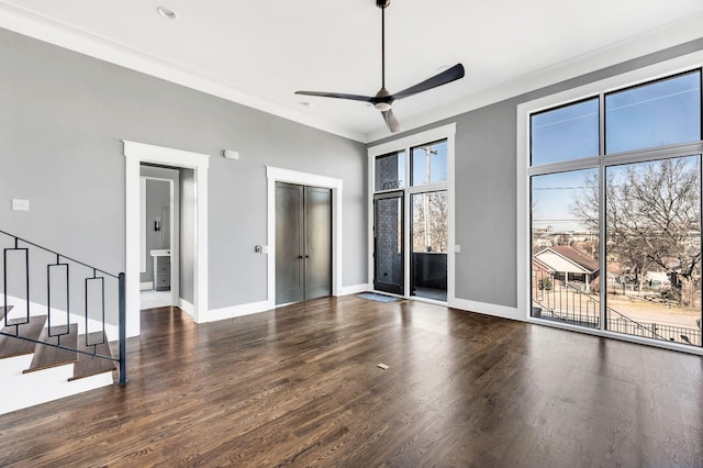 unfurnished bedroom featuring access to exterior, ornamental molding, wood finished floors, and baseboards