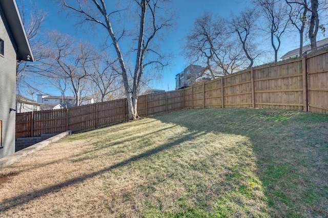 view of yard with a fenced backyard