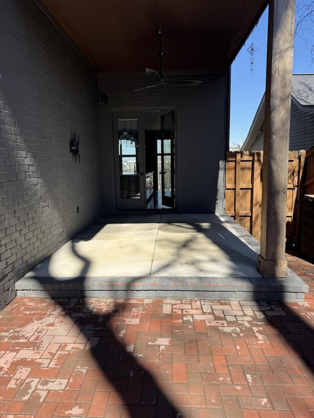 view of patio with ceiling fan, fence, and french doors