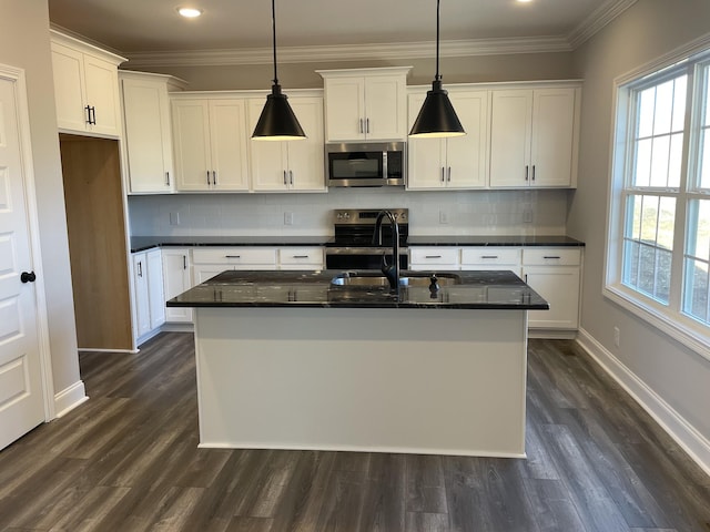 kitchen with a healthy amount of sunlight, white cabinetry, appliances with stainless steel finishes, and crown molding