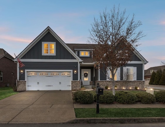 craftsman house with board and batten siding, a garage, concrete driveway, and brick siding