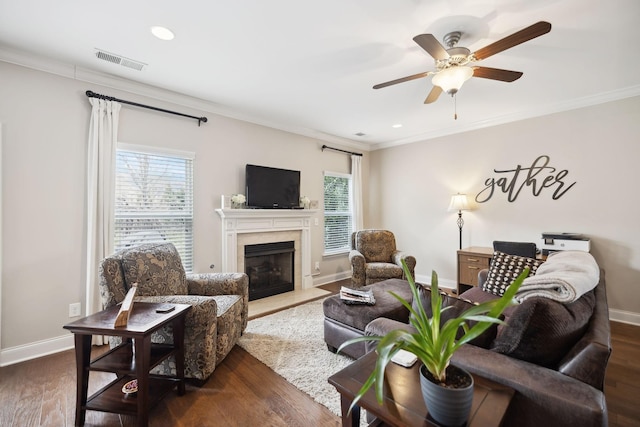 living room with ornamental molding, a healthy amount of sunlight, and visible vents