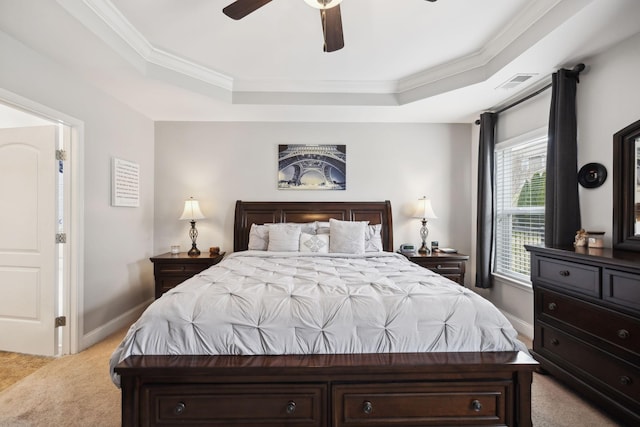 bedroom featuring baseboards, a raised ceiling, visible vents, and light colored carpet