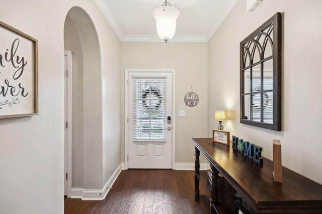 doorway to outside featuring arched walkways, baseboards, dark wood finished floors, and crown molding