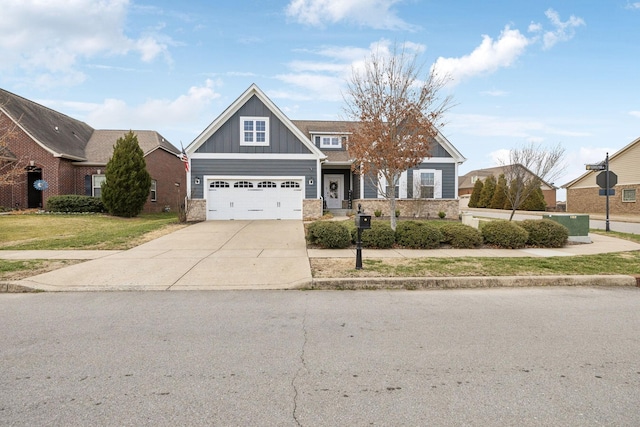 craftsman-style home with driveway, board and batten siding, and a front yard