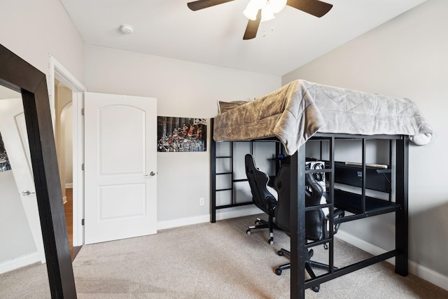 carpeted bedroom with ceiling fan and baseboards