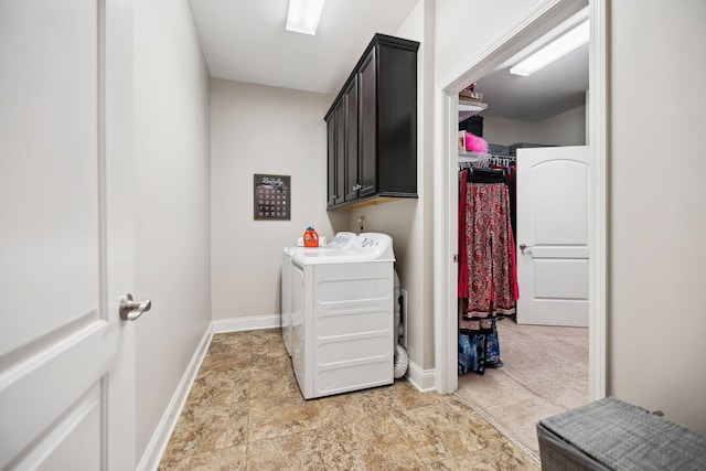 laundry area with baseboards, cabinet space, and washer and dryer