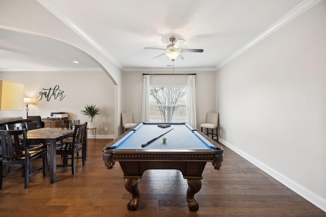 game room with arched walkways, crown molding, baseboards, and wood finished floors