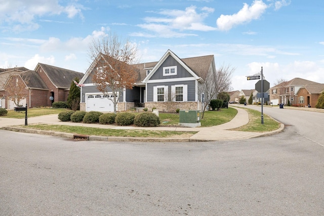 view of front of property featuring an attached garage, a residential view, cooling unit, and board and batten siding