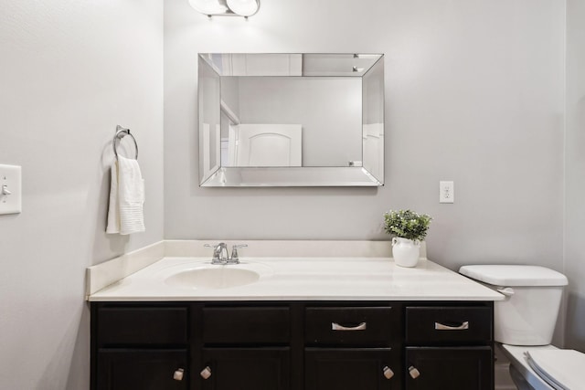 bathroom with toilet and vanity